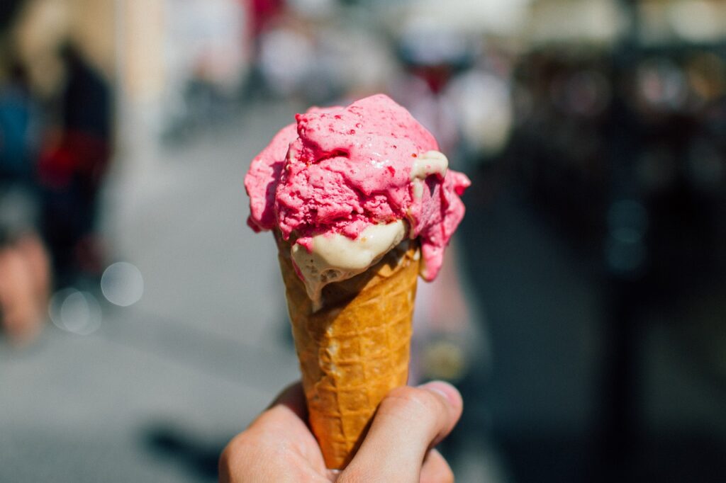 Person holding ice cream cone outside