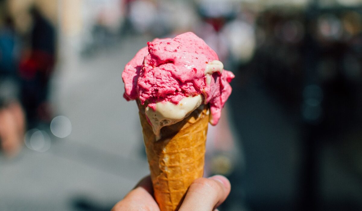 Person holding ice cream cone outside