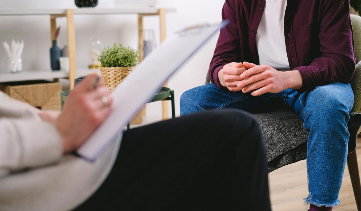 Close up of dietitian writing notes during client session