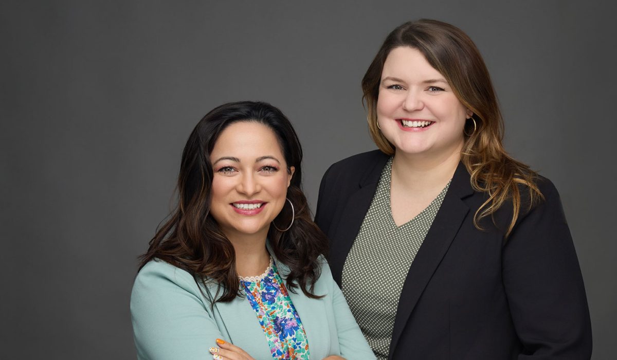 Two women standing in photo studio