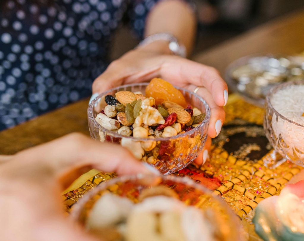 Woman holding glass container of trail mix