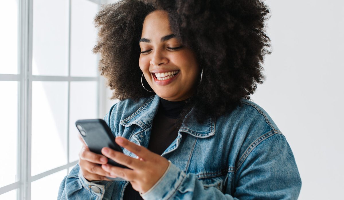 Woman smiling looking at phone