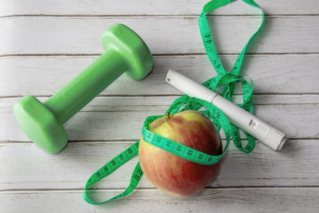 Weight GLP-1 Apple Tape Measure on table