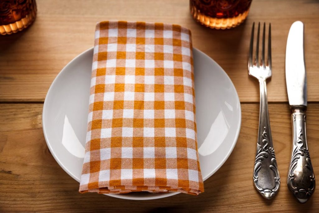 Empty plate setting with checkered napkin on top