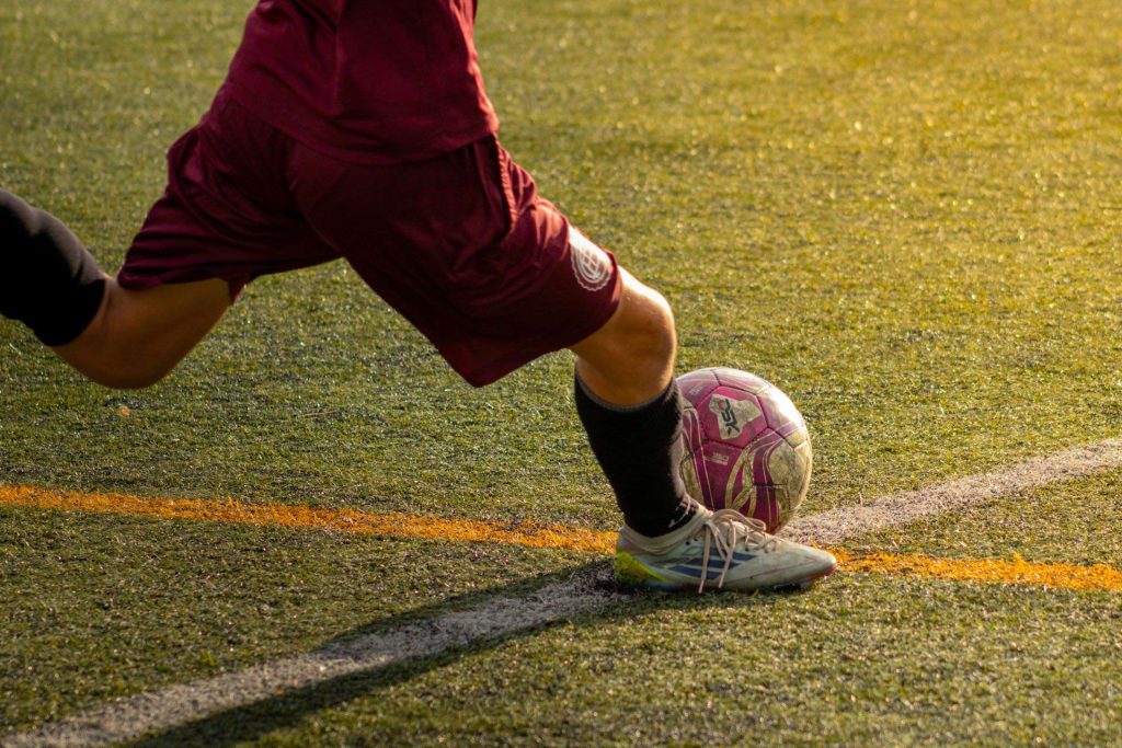 Close up of soccer player kicking ball